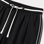 Women's black relaxed trousers detail view