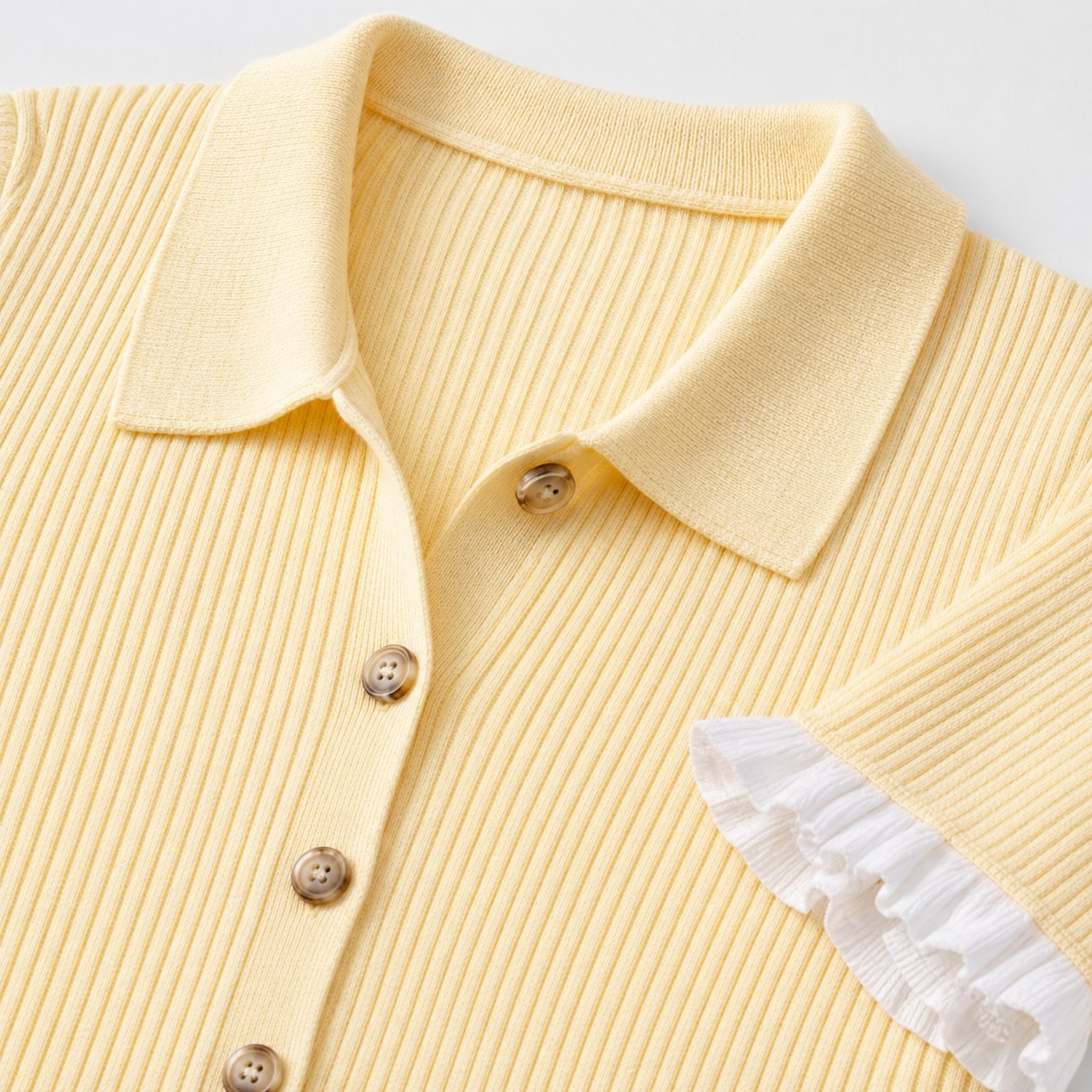 Pale yellow ribbed knit dress collar and button detail