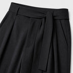 Black men's wide-leg pleated trousers waistband and pleat detail