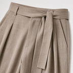 Khaki men's wide-leg pleated trousers waistband and pleat detail