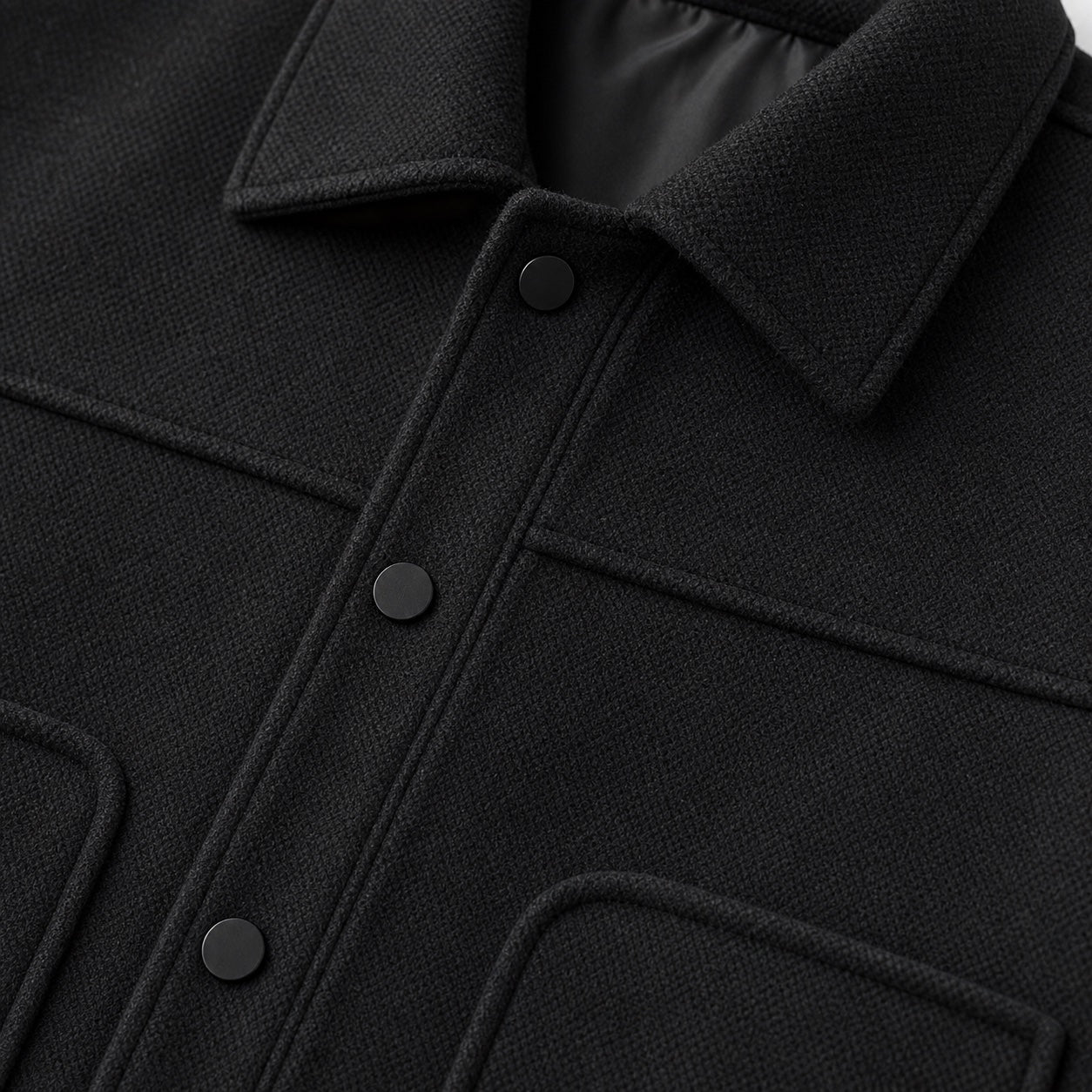 Black men's wool jacket fabric and pocket detail
