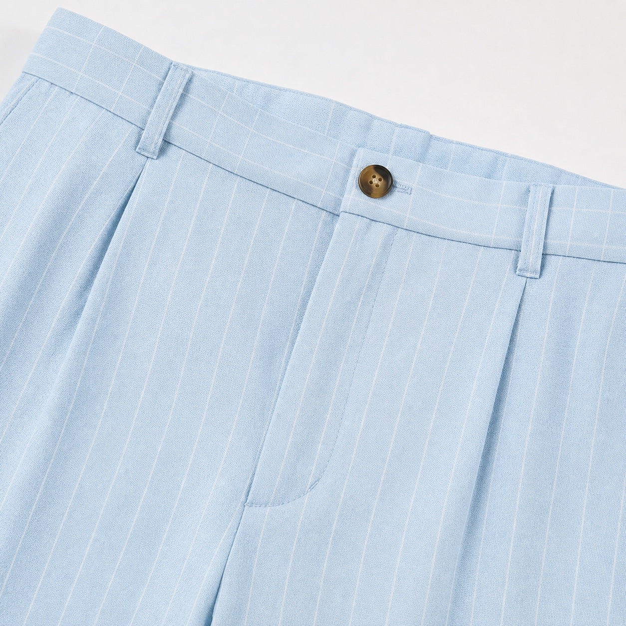 Men's light blue pinstripe pleated trousers waistband detail