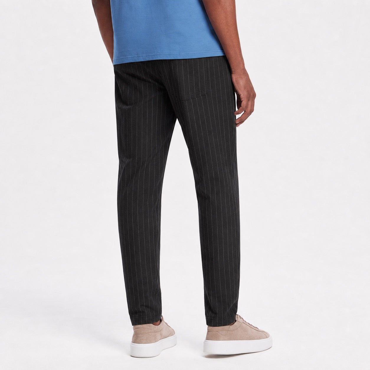 Men's black pinstripe pleated trousers back view