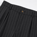 Men's black pinstripe pleated trousers waistband detail