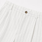 Men's white pinstripe pleated trousers waistband detail