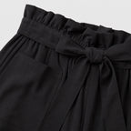 Black paperbag-waist shorts detail