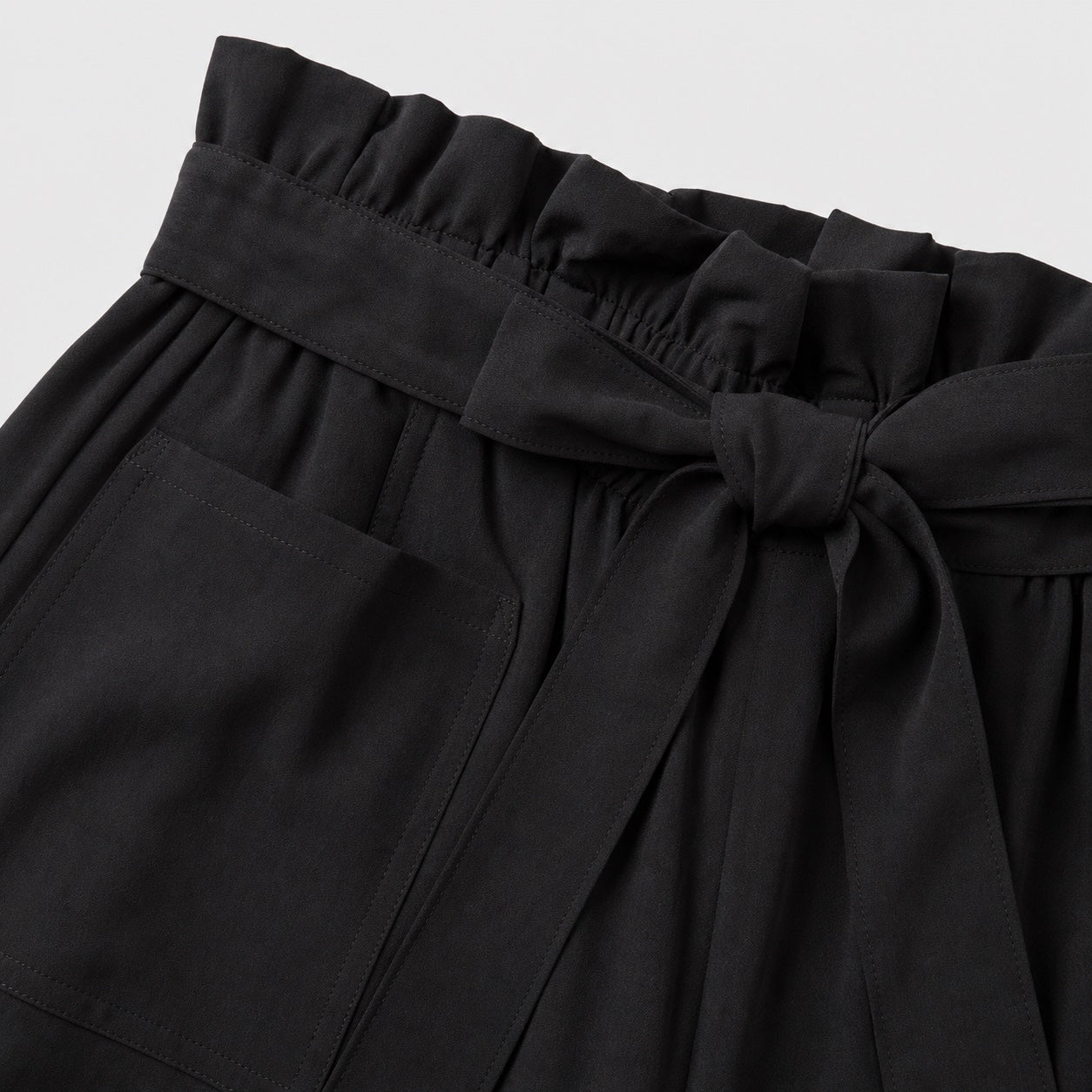 Black paperbag-waist shorts detail