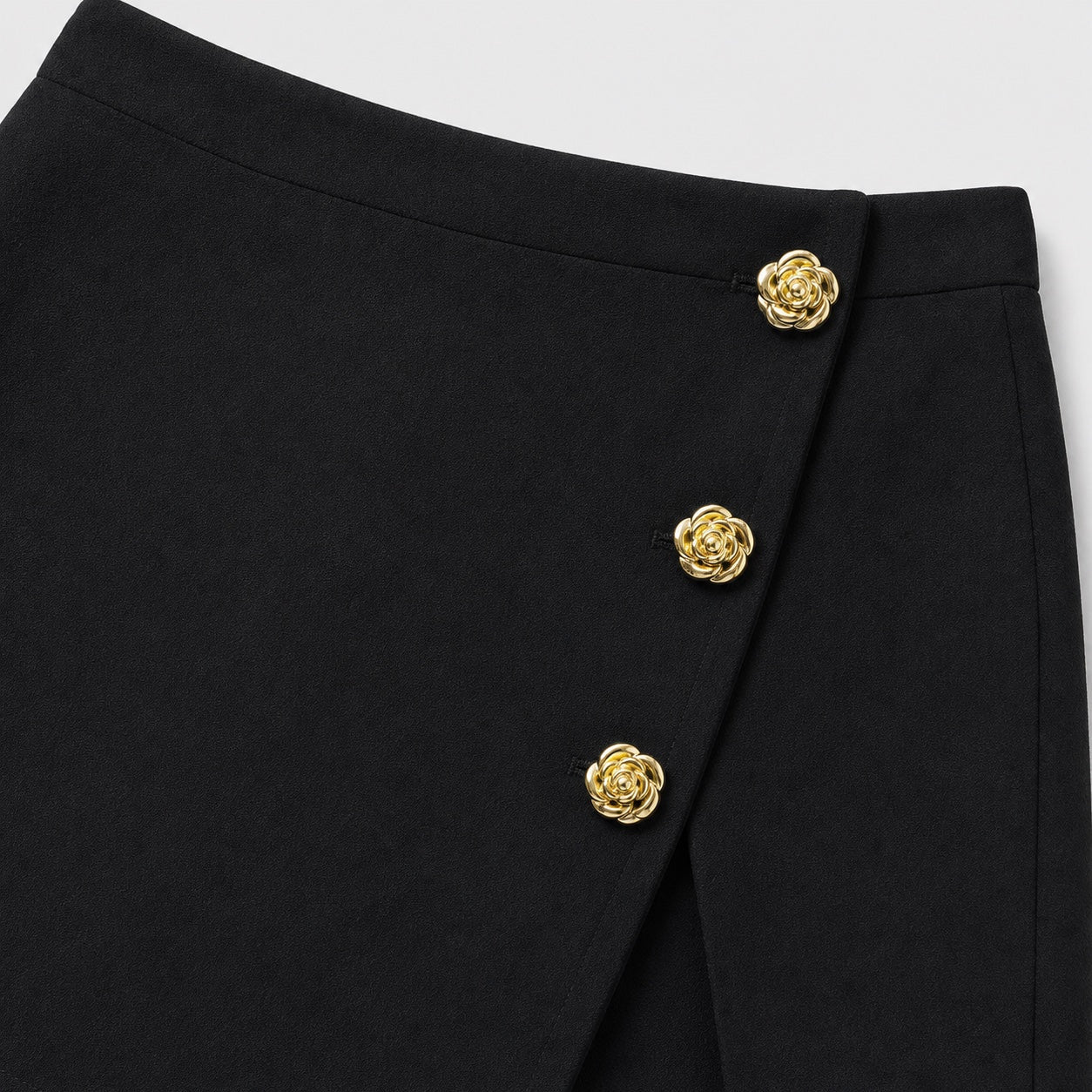 Black button-detail wrap-front skort detail